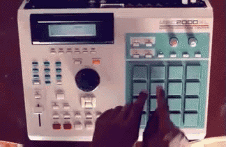 a person is pressing a button on a machine that says mpk 2000