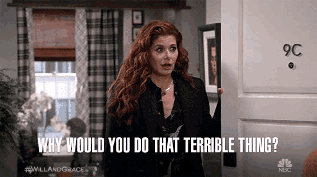 a woman with red hair is standing in front of a door that says 9c