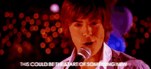 a young man singing into a microphone with the words this could be the start of something new below him
