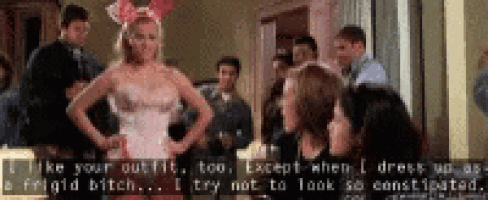 a woman in a playboy bunny costume is standing in front of a group of people