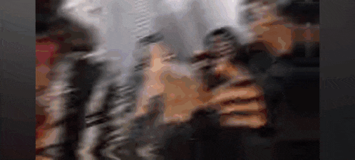 a blurry picture of a person holding a microphone in their hand .