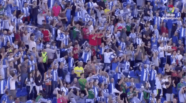a large crowd of people are watching a soccer game in a stadium