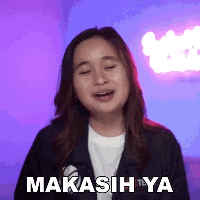 a girl in a jacket says makasih ya in a purple background