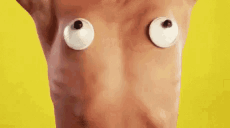 a close up of a person 's torso with googly eyes on it .