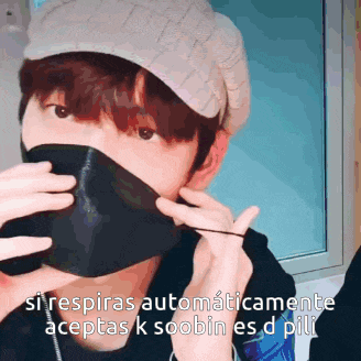 a man wearing a hat and a mask says " si respiras automaticamente aceptas k soobin es d pili " .