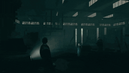 a man is standing in a dark room with a few lights on