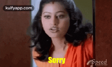 a woman in a red dress is making a sorry gesture .