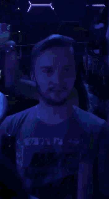 a man wearing a nike shirt looks to the side
