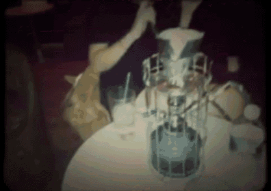 a blurred image of a person sitting at a table