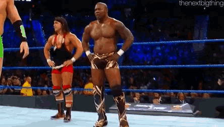 two wrestlers are standing in a wrestling ring with the nextblgthing written in the corner