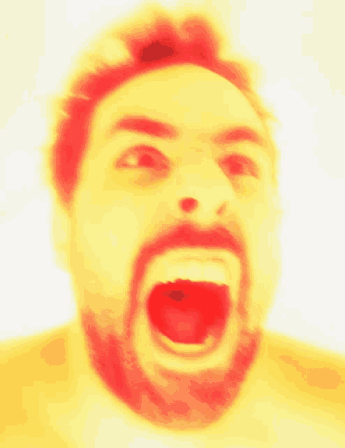 a man with a beard is making a funny face with his mouth open