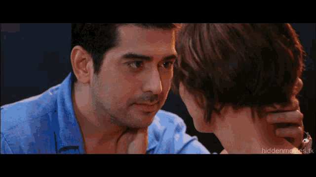 a close up of a man and woman 's faces with the words hiddenmovies.tk visible in the corner