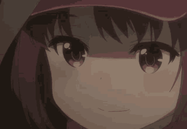 a close up of a girl 's face with a pink hat on