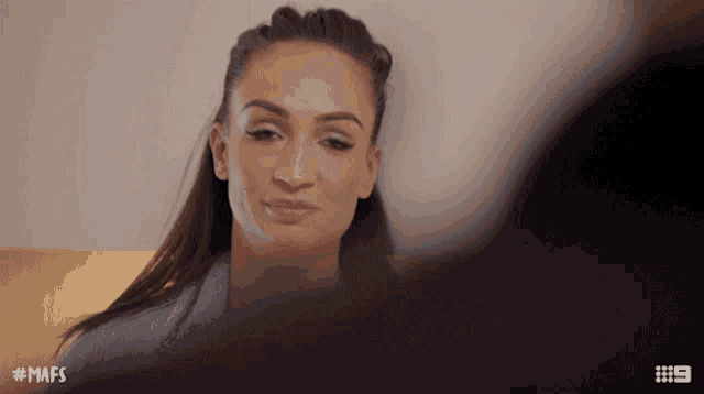 a woman leaning against a wall with the hashtag mafs