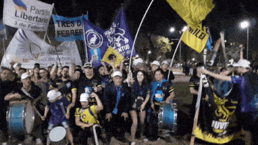 a group of people holding flags with one that says partido libertario