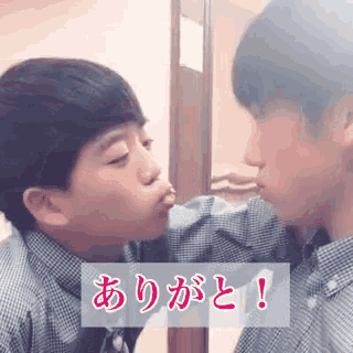 a boy kissing his reflection in a mirror with chinese writing on the bottom