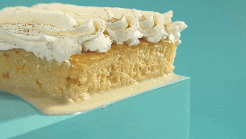 a piece of cake with whipped cream and cinnamon sprinkles
