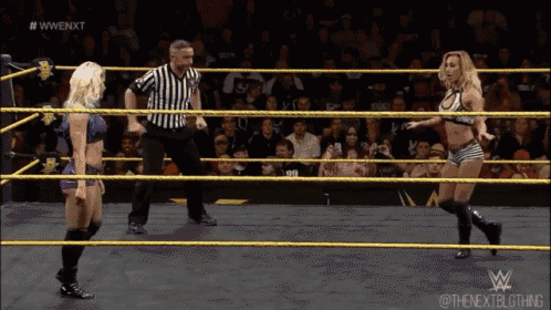 a woman in a wrestling ring with a referee and the words #wwe nxt on the bottom