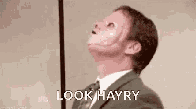 a man in a suit and tie with a scar on his face .