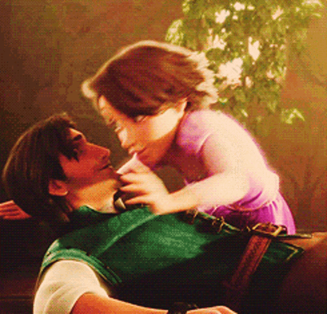 a man is holding a little girl in his arms