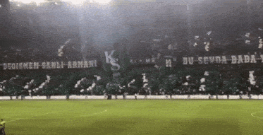 a soccer field with a banner that says ' degismen sanli armani ' on it