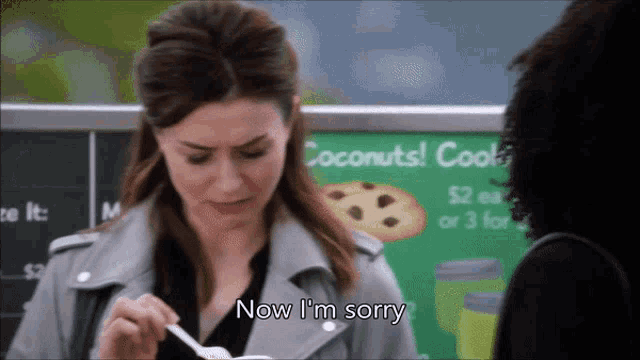 a woman in front of a sign that says coconuts cooks