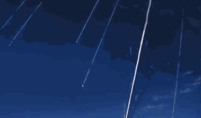 a blue sky with a few shooting stars