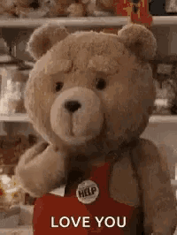 a teddy bear is wearing a red apron and holding a heart in his hand .