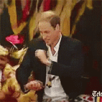 a man in a suit and tie is dancing in front of a crowd .