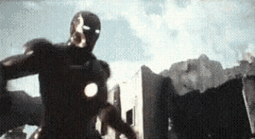 a man in a superhero costume is standing in front of a building in a city .