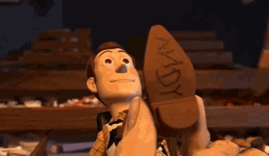 woody from toy story is holding a cowboy boot