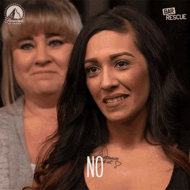 a woman with a tattoo on her chest is smiling and says no