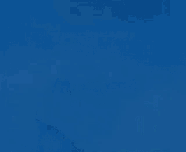 a woman 's fist with a ring on it is coming out of a hole in a blue wall .