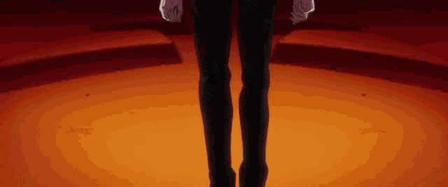 a close up of a person 's legs standing on a stage in a dark room .