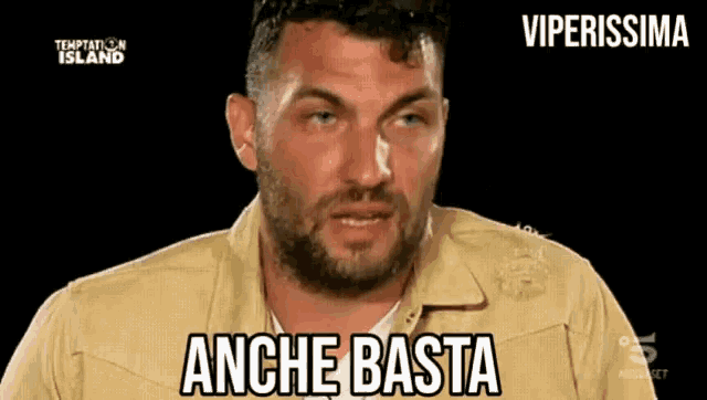 a man with a beard and a tan jacket says anche basta