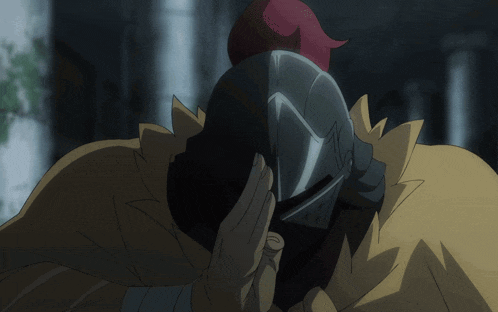 a man wearing a knight 's helmet and a yellow cape with a cross on it
