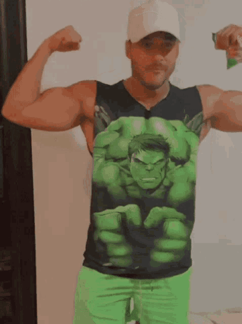 a man wearing a black tank top with the hulk on it