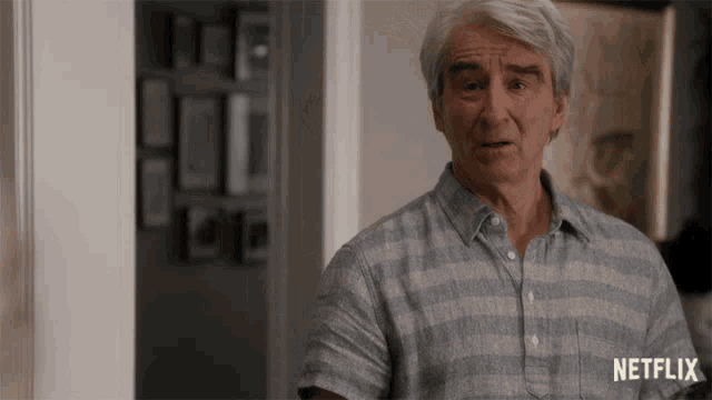a man in a striped shirt has a netflix logo on his shirt