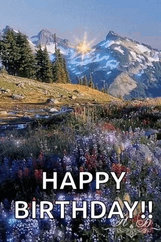 a birthday card with a mountain in the background and a field of flowers