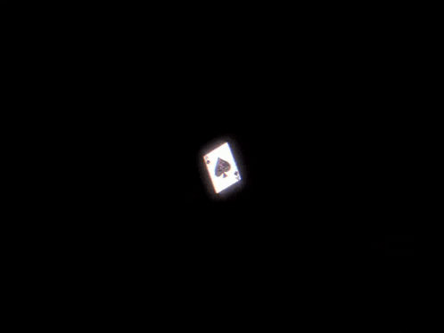 an ace of spades playing card against a black backdrop