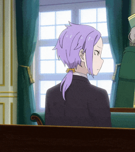 a woman with purple hair is sitting in a chair