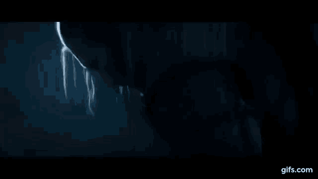 a close up of a person 's face in a dark room in a movie .