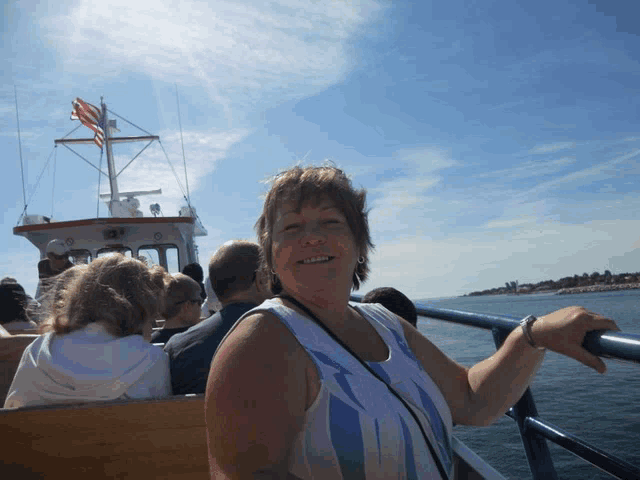 a woman on a boat with a flag on top