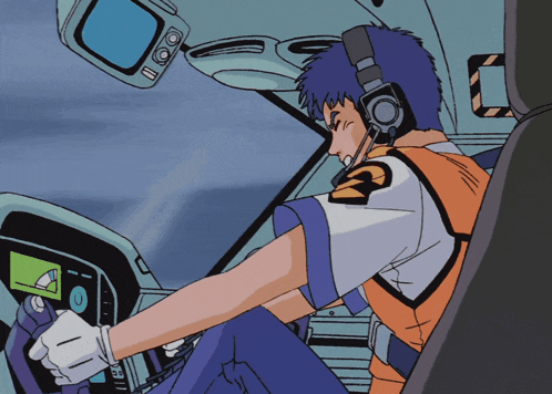 a man wearing headphones and a vest with the letter g on it is sitting in a car