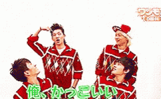 a group of young men in red sweaters are standing next to each other .