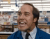 a man in a blue jacket and tie is making a funny face .