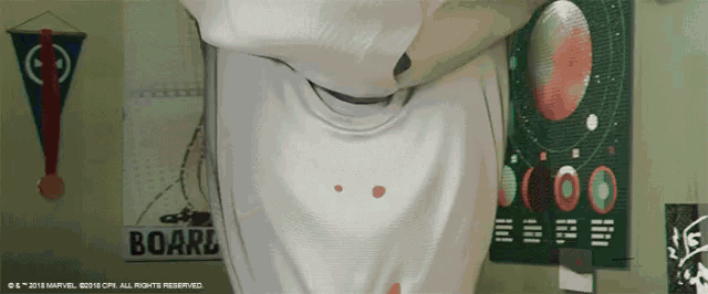 a sign that says boarl hangs on a wall next to a person 's shirt