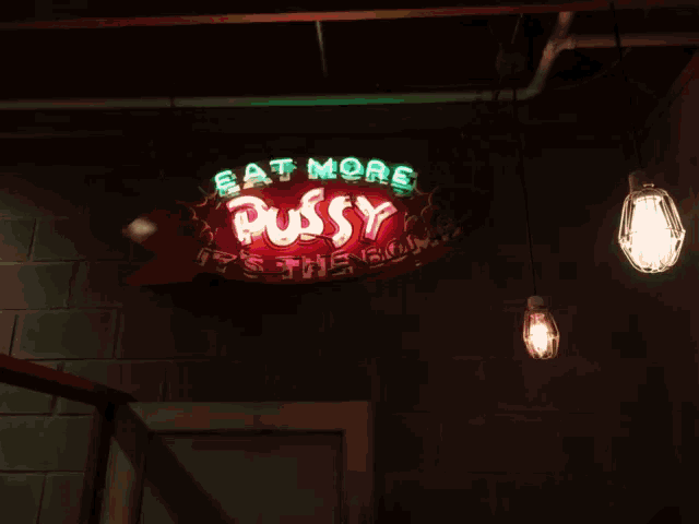a sign that says " eat more pussy it 's the bomb "