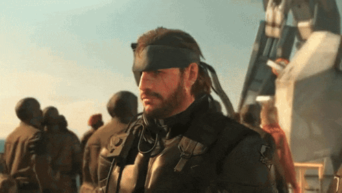 a man with a beard is wearing a black headband with a snake on it