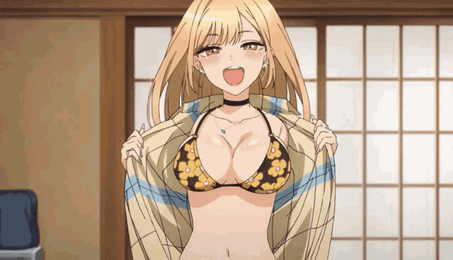 a girl in a bikini is taking off her shirt and smiling